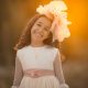 una niña feliz en su vestido blanco de encaje el dia de su primera comunión
